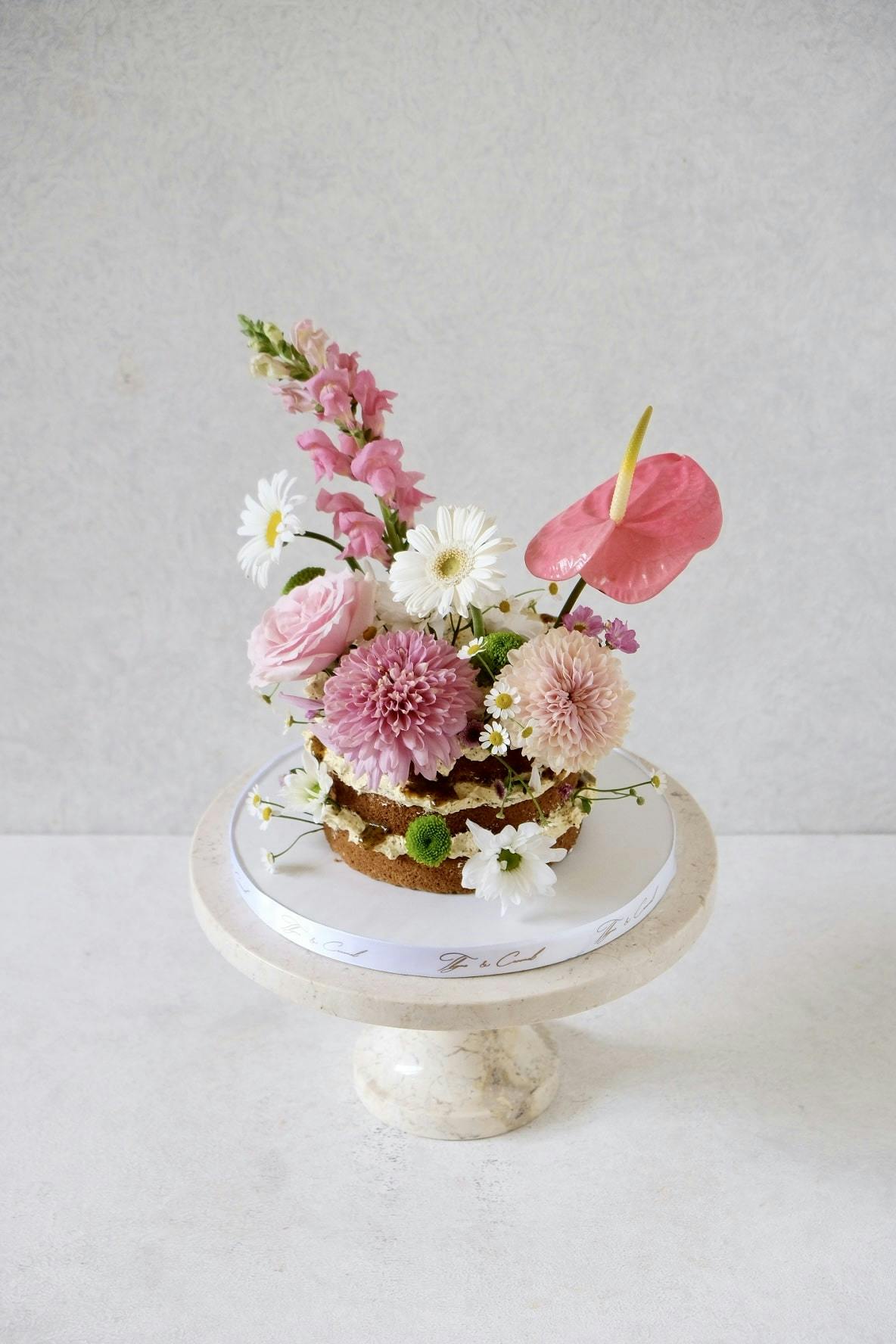 naked flower birthday cake with colorful flowers