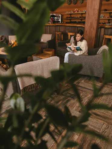 femme lisant assise sur un canapé dans un salon cocooning