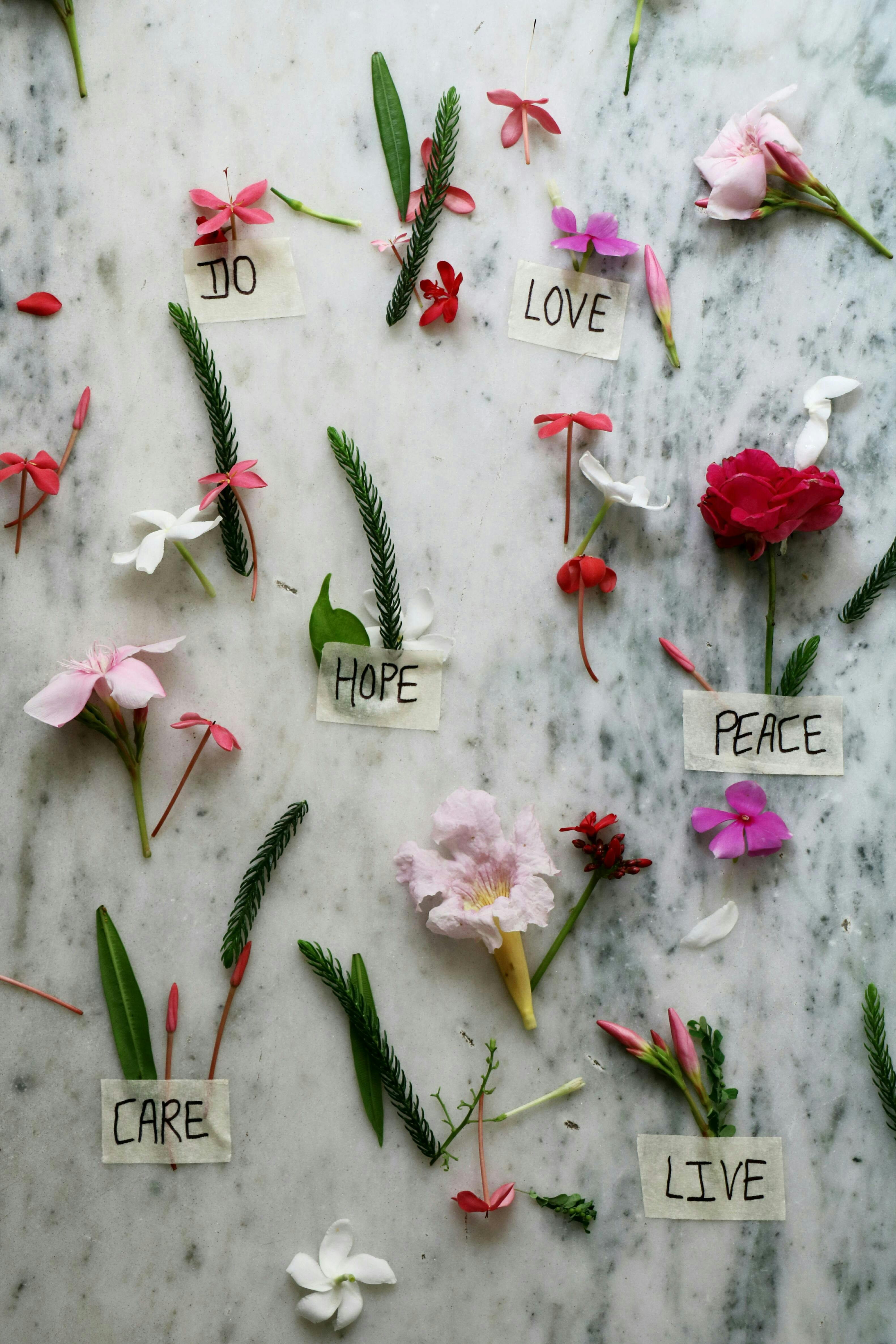 des fleurs posées sur une table effet marbre et des mots en anglais