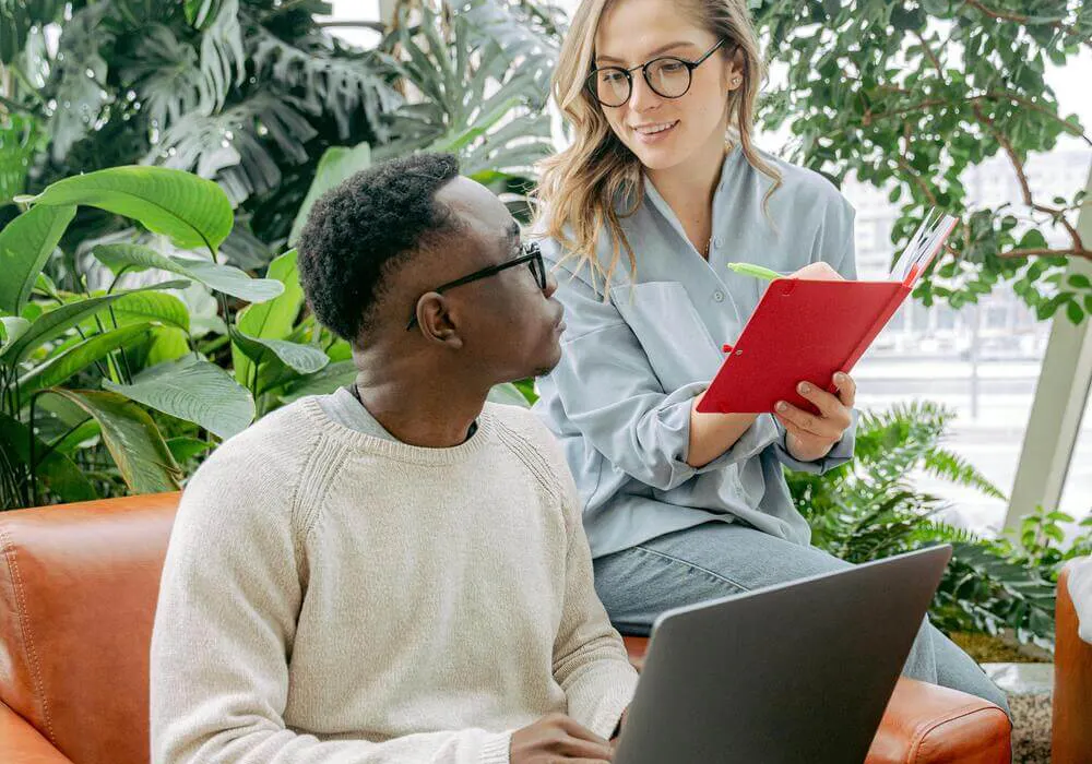 Man and woman working together with laptop