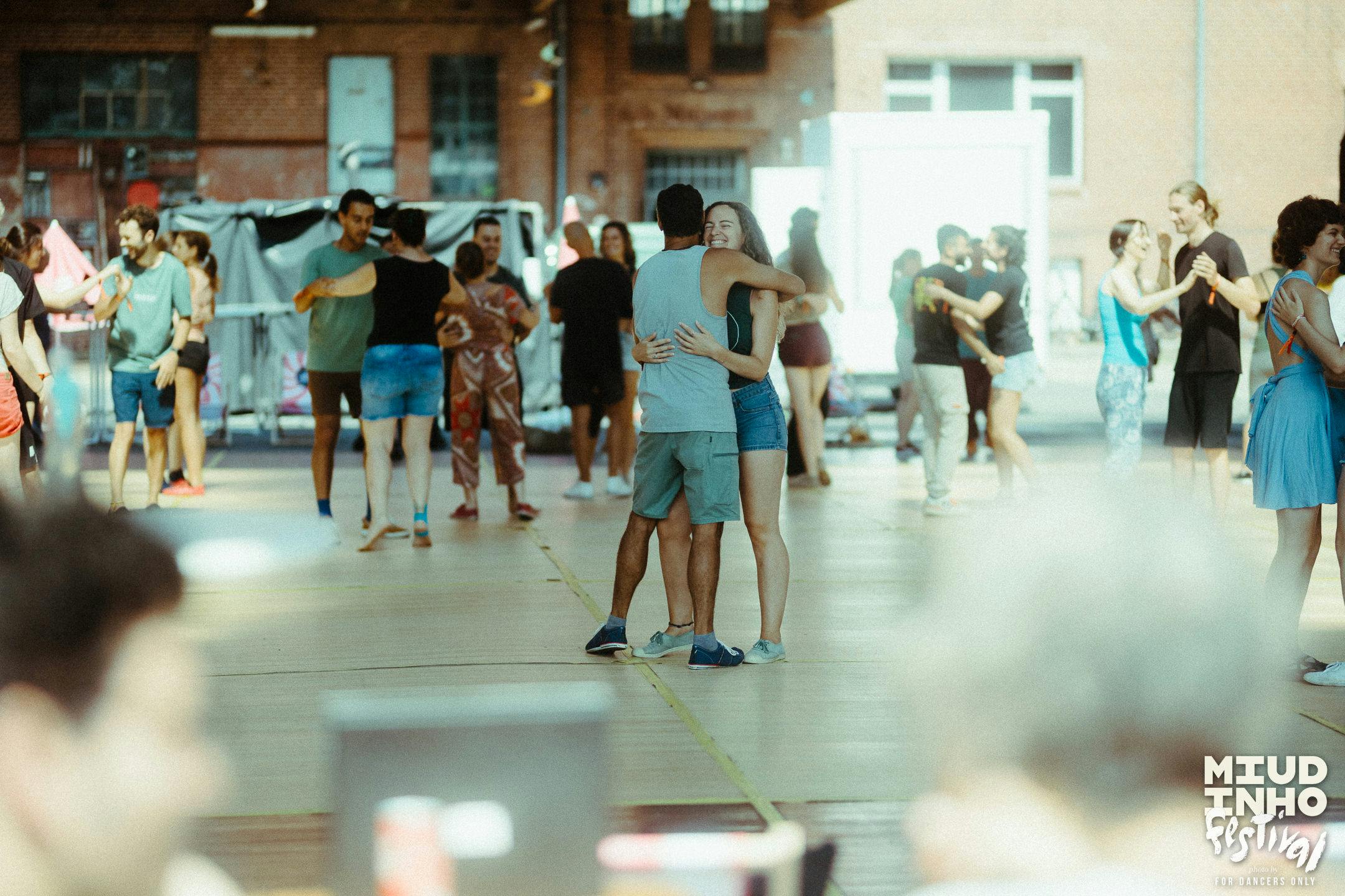 A snapshot of a partner dance class with people dancing in pairs at Miudinho Festival 