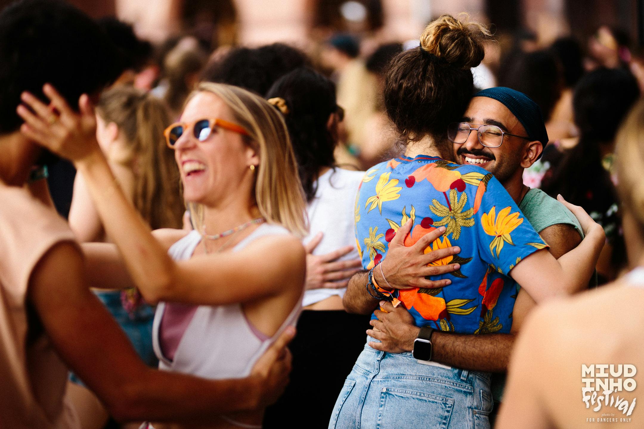 A shot of a crowd of people focusing on two couples interacting with one another at Miudinho Festival 