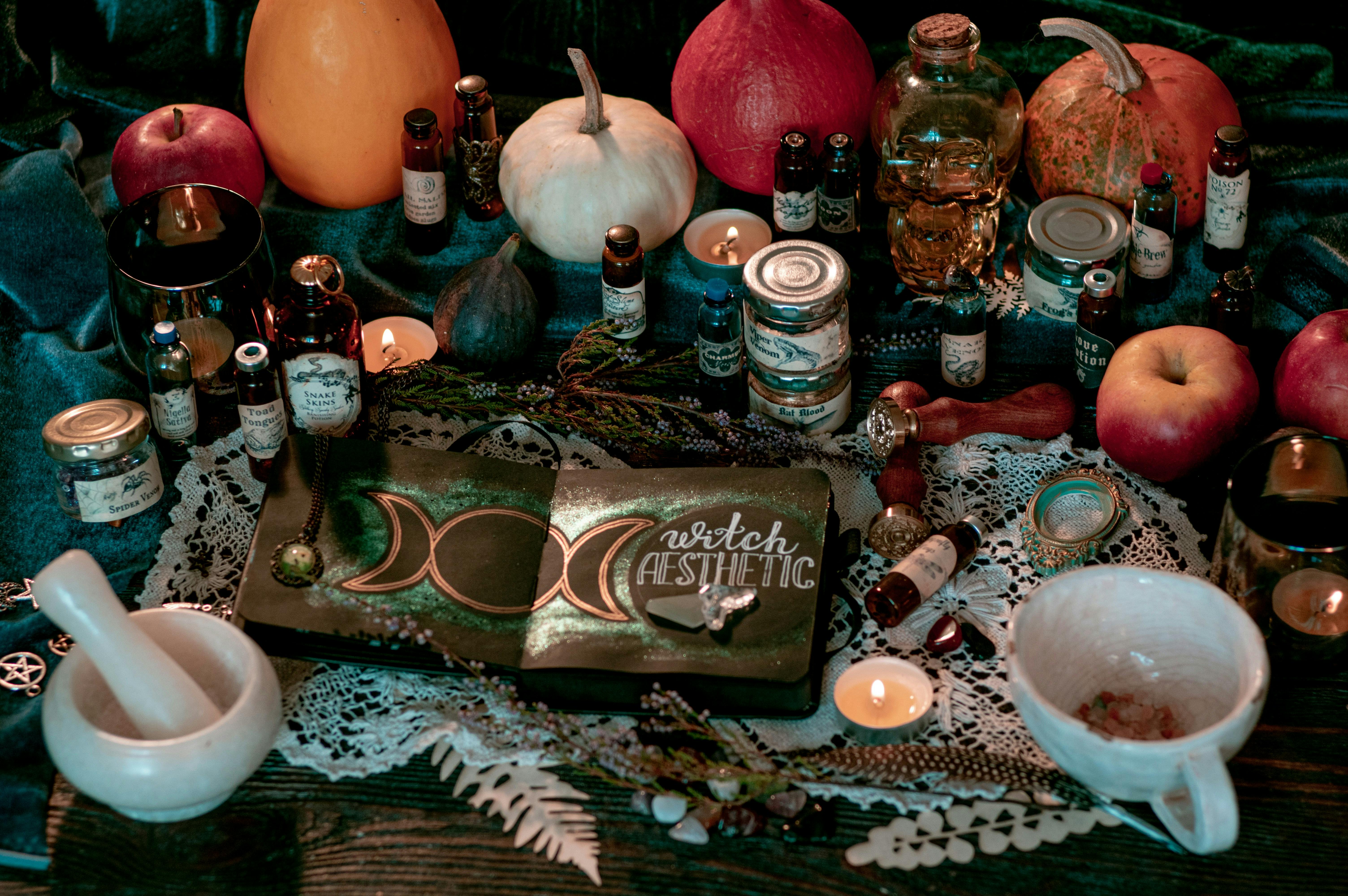 A collection of items in the witch aesthetic – pumpkins, candles, herbs
