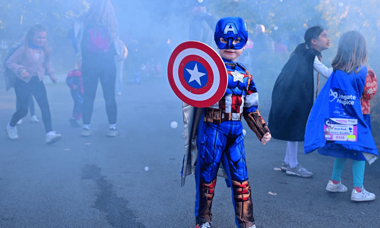 A boy dressed up as a superhero posing for the camera against a misty backdrop – Ashgate Hospice Night Walk Fundraiser