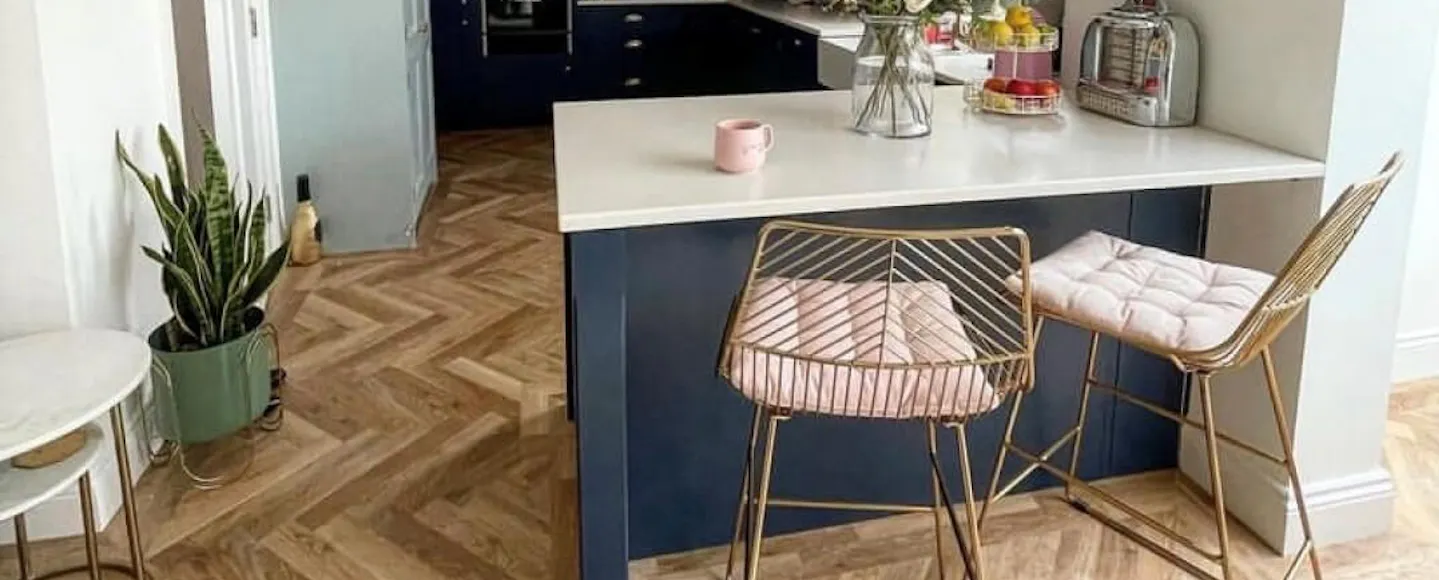 dark blue kitchen island with white countertops
