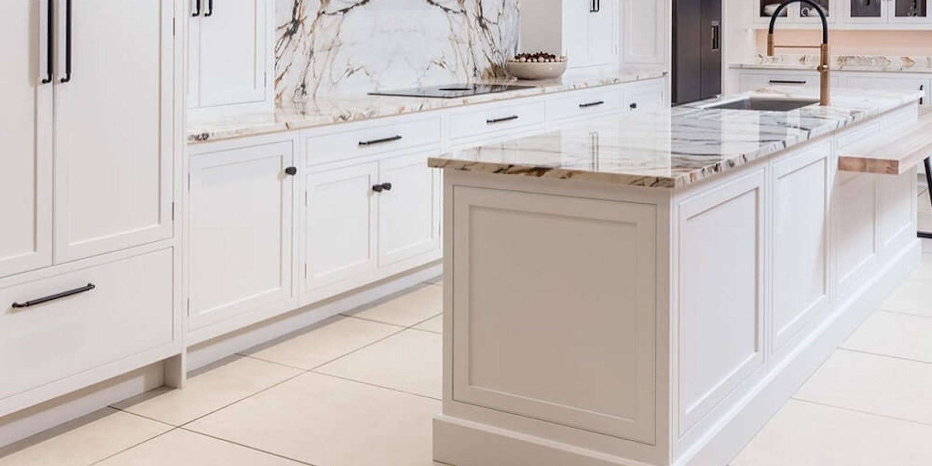 White kitchen cabinets with a marble worktop