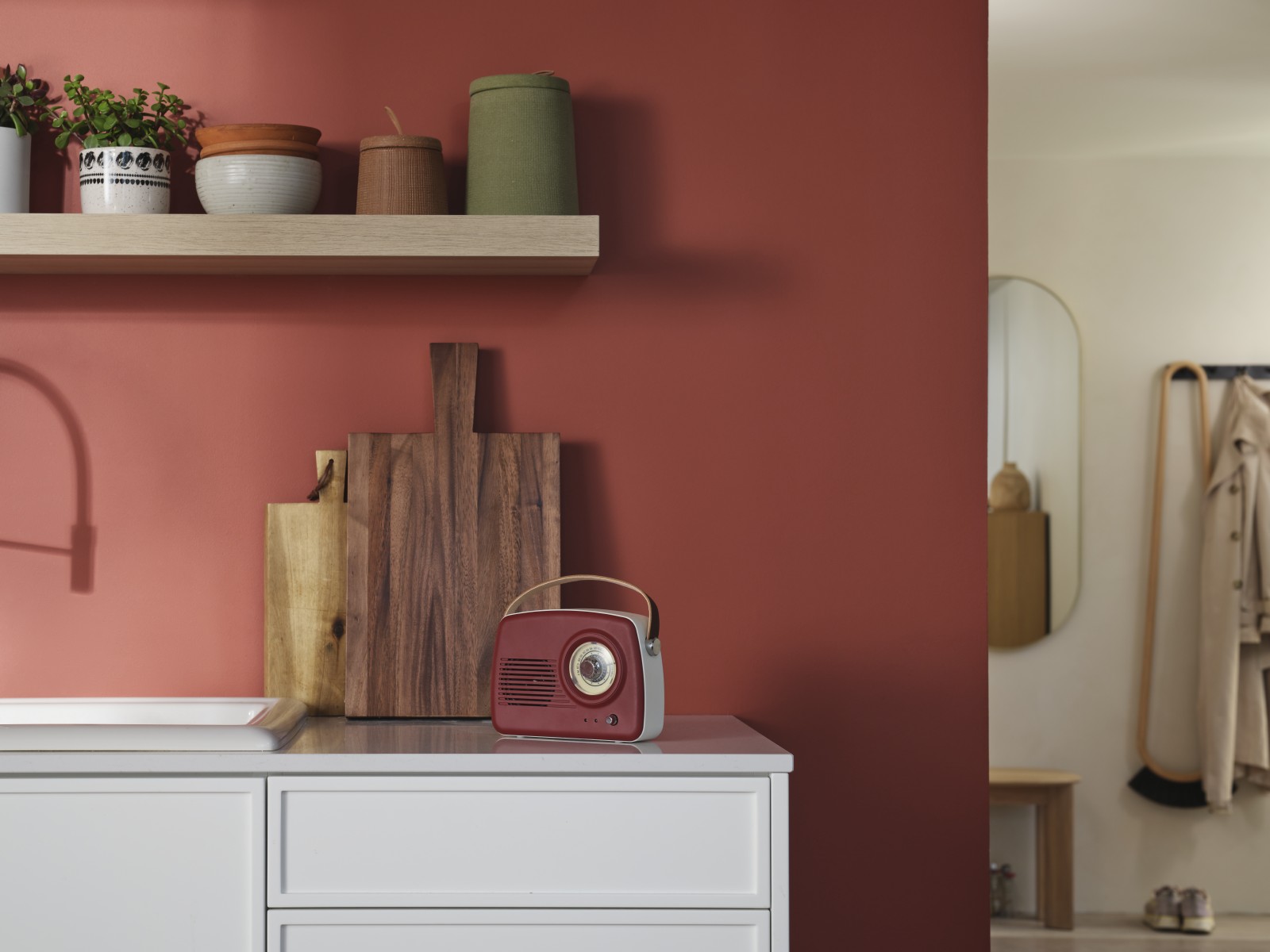 red radio on a kitchen counter in front of red wall painted in shade madras n411