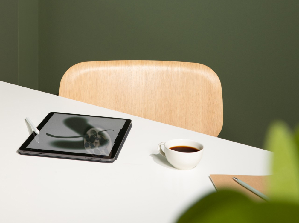 Green wall with white desk