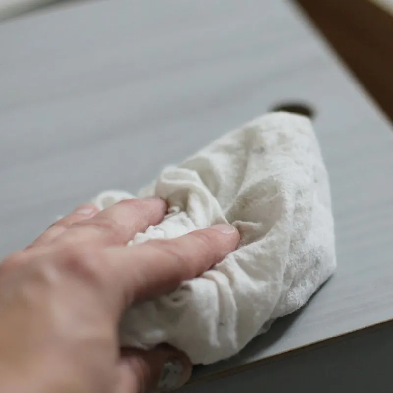 Hand Cleaning Disassembled Drawer with Cloth
