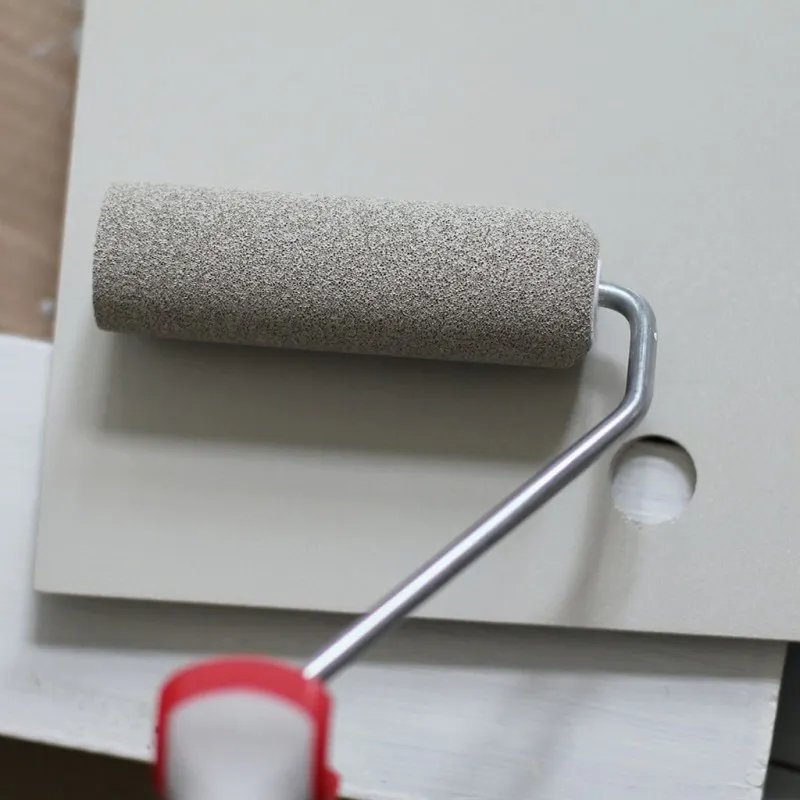 Paint Roller on Top of White Piece of Wood