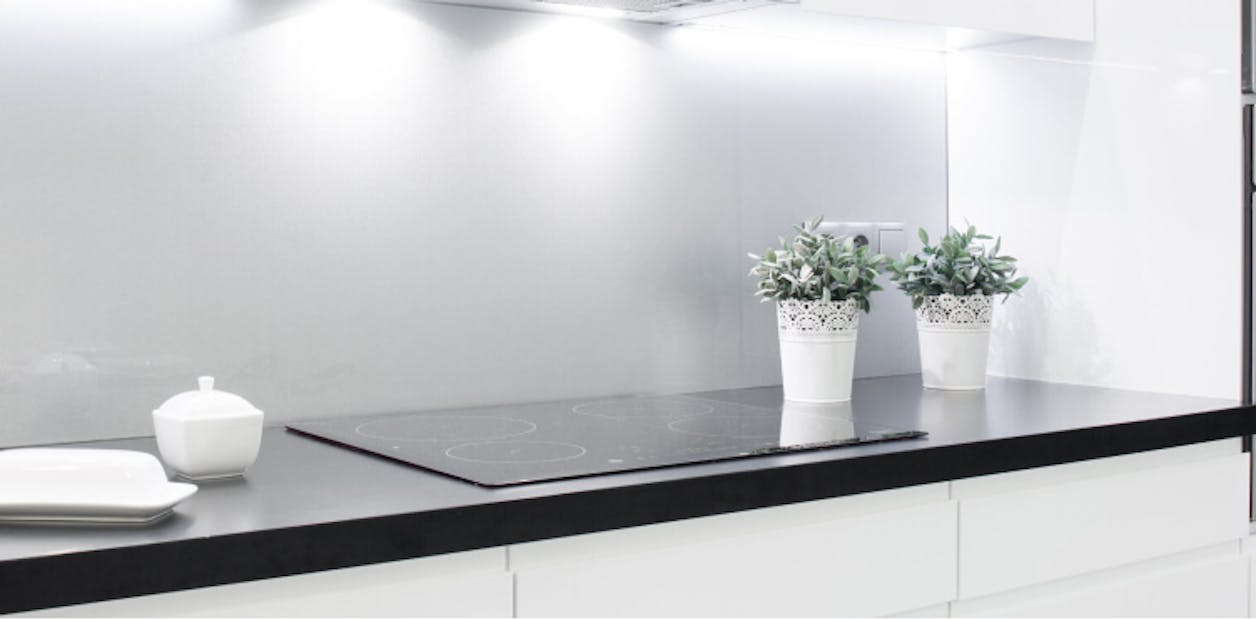 black kitchen worktop with a grey wall
