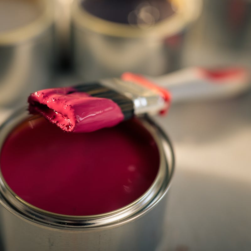 Open Tin of Red Paint and Dipped Brush