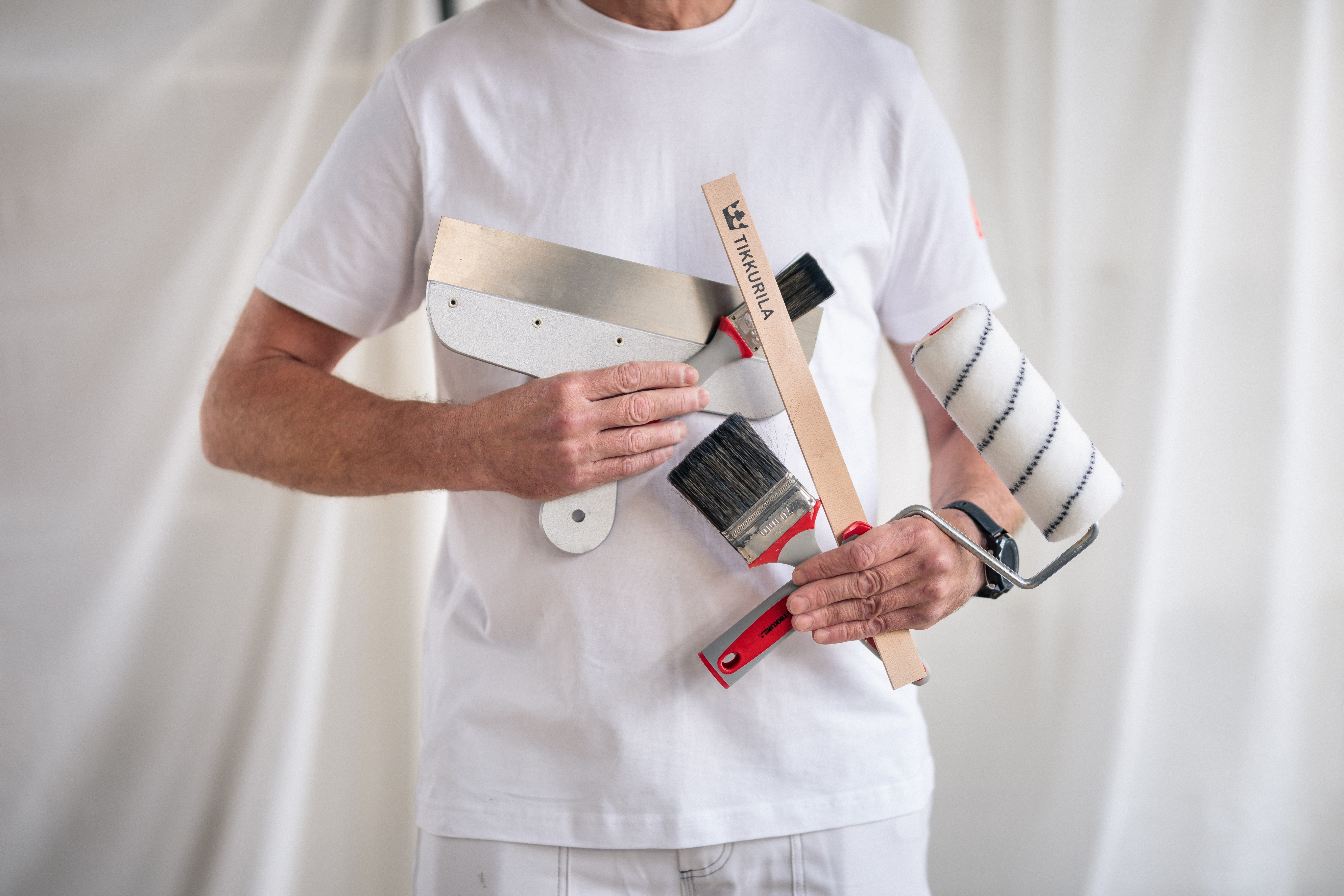 Painter in White Clothes Holding Painting Tools
