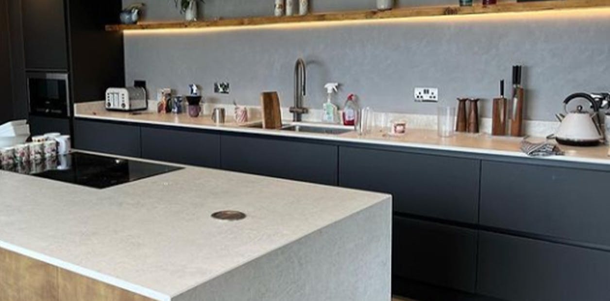 blue kitchen cabinets with a marble kitchen island