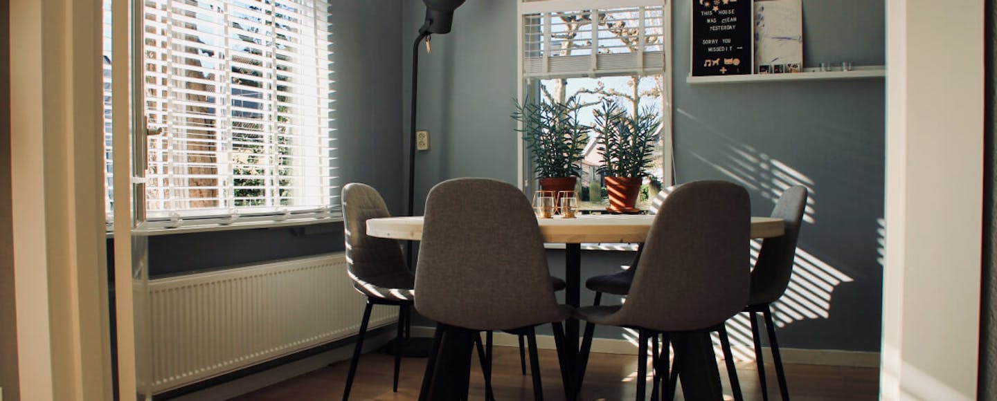 Green dining room with a large window