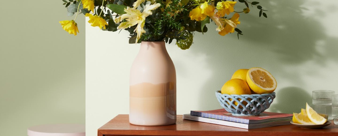 bouquet of flowers against light green wall