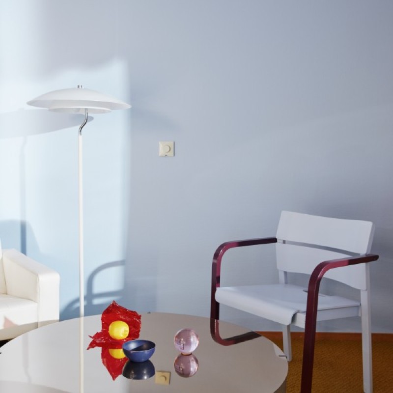 coffee table and chair in front of light blue and cream wall
