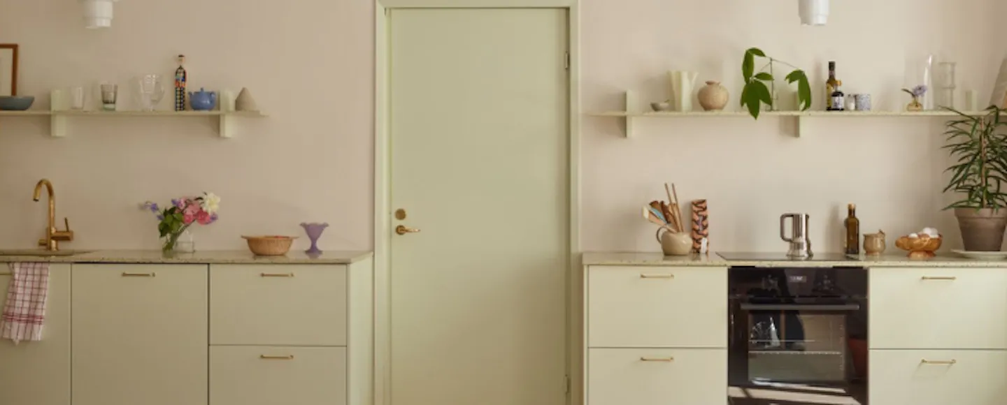 kitchen painted with a pale green shade and a neutral
