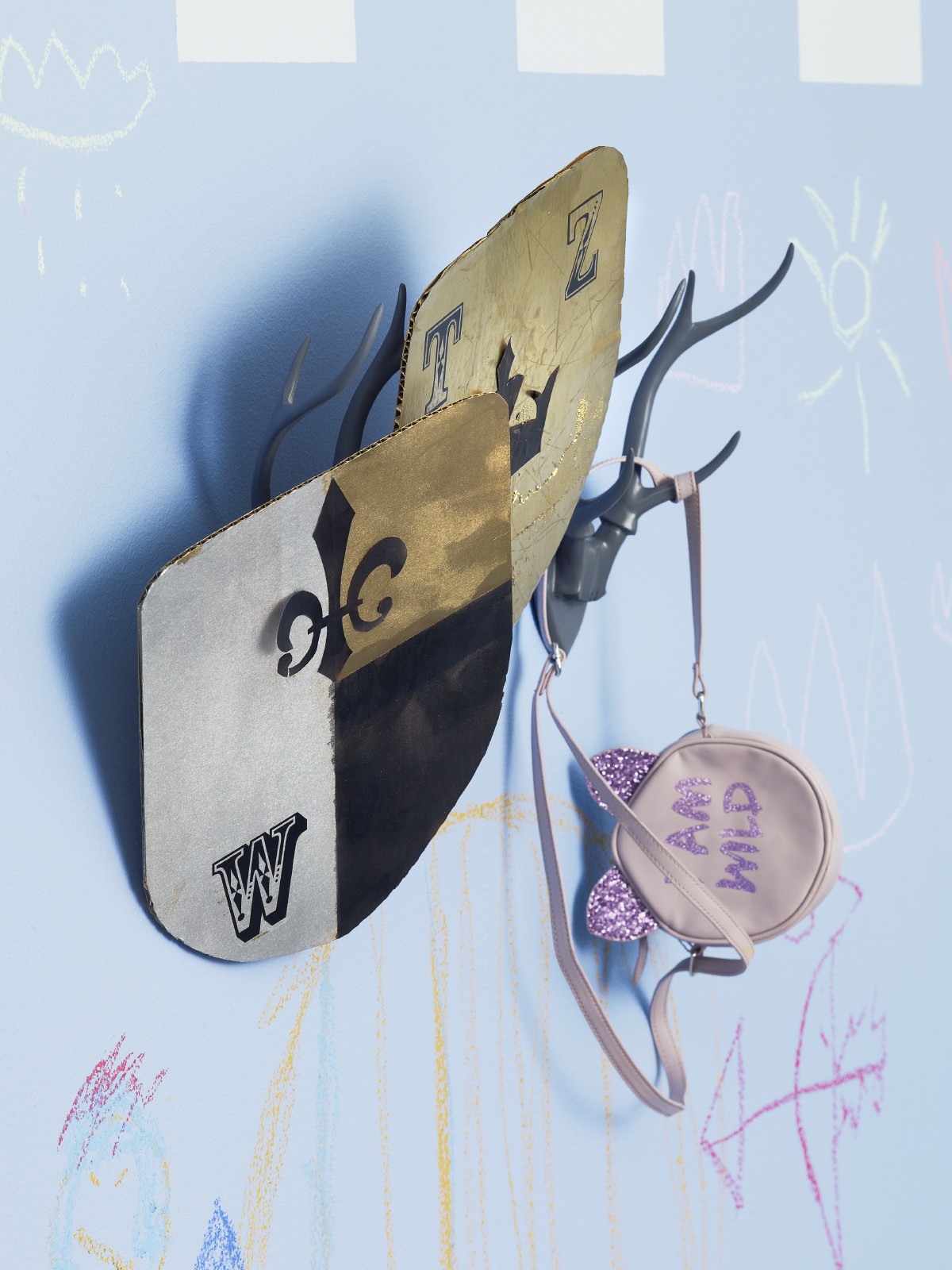 shield and purse hanging on a wall