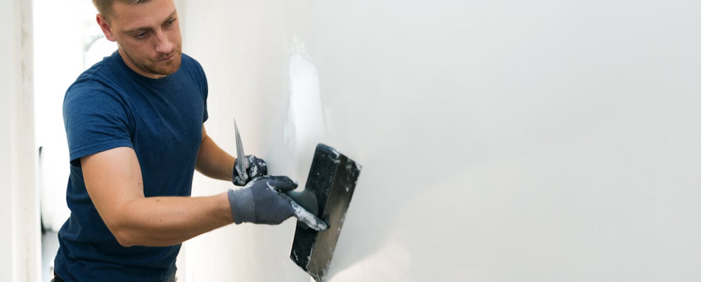 man plastering a wall