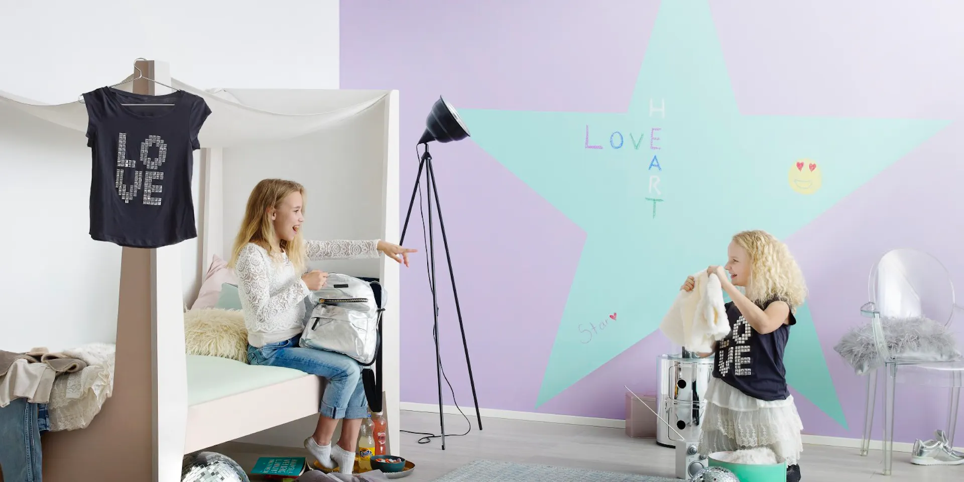 Blue Chalkboard Star on Purple Wall and Two Kids Playing
