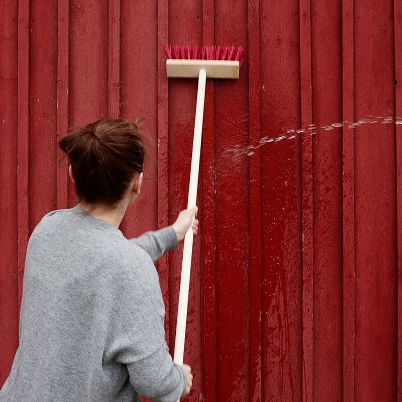 wipe down the wall with a brush