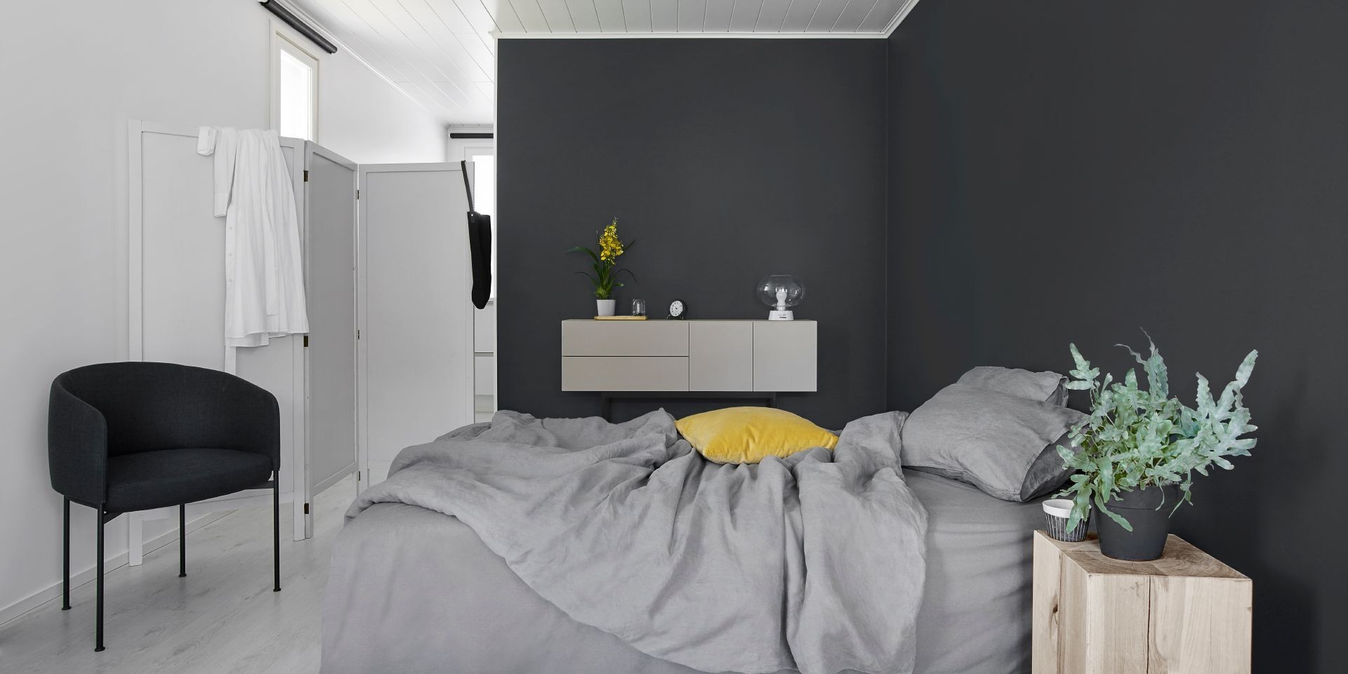 Grey Bed Against Dark Grey Feature Wall