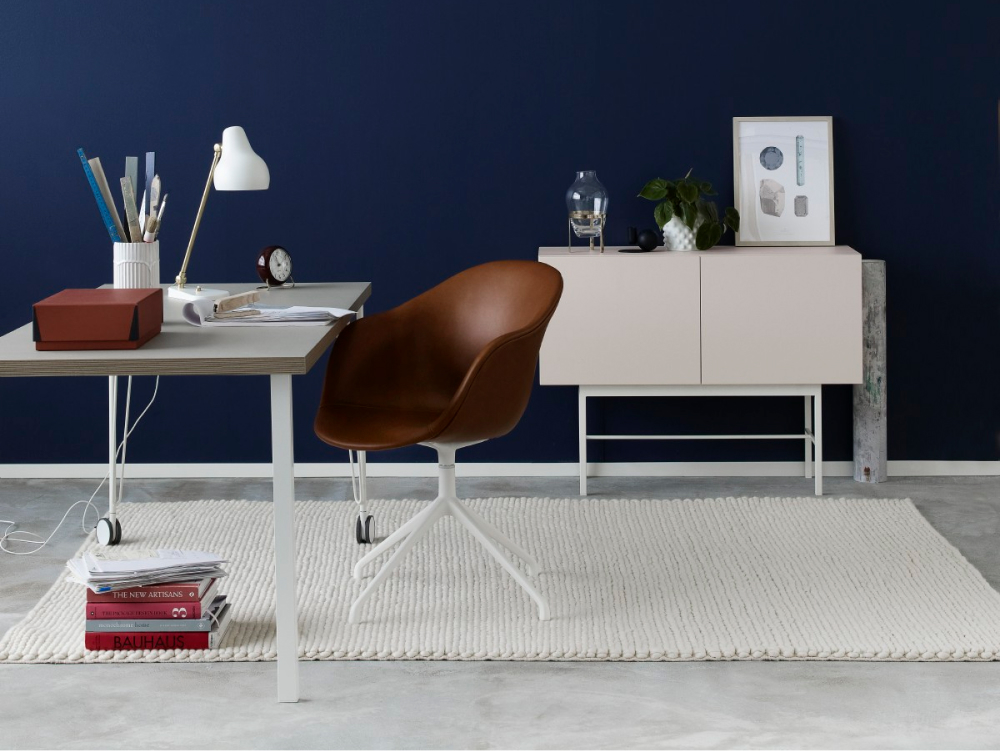 blue wall with wooden desk