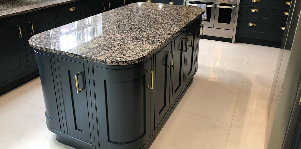 kitchen with dark blue island in the centre