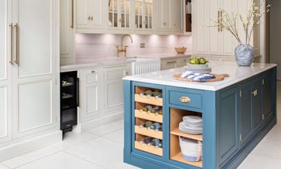 blue kitchen island in front of white kitchen cabinets