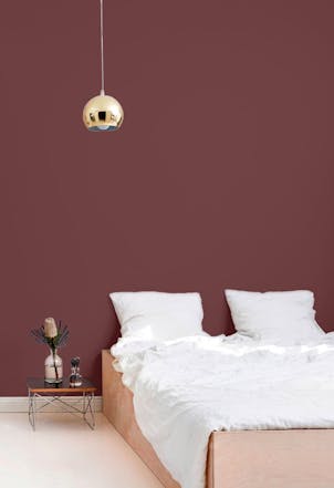 bedroom with a warm maroon wall