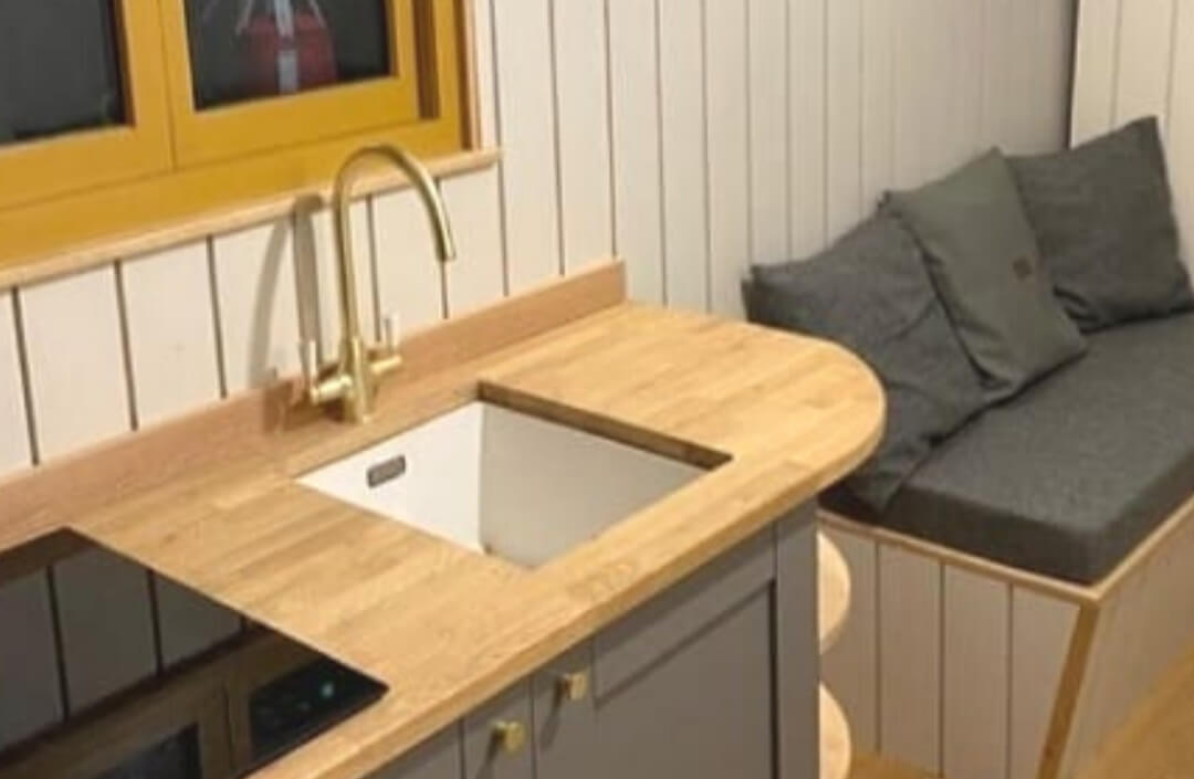 Grey cabinets with a natural wood worktop