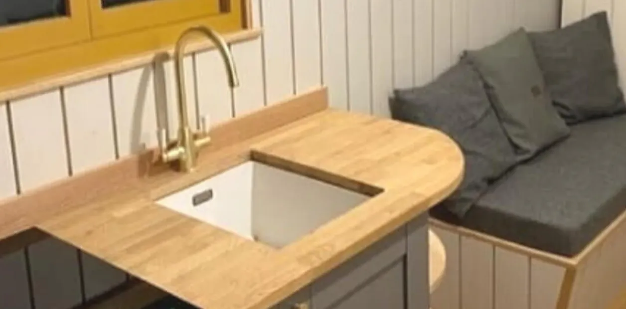 Grey cabinets with a natural wood worktop