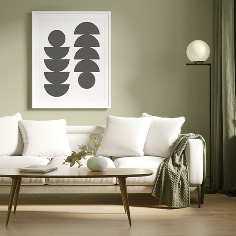 sofa and coffee table in front of sage green wall