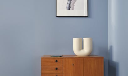 wooden cabinet against blue wall painted in sandman v431