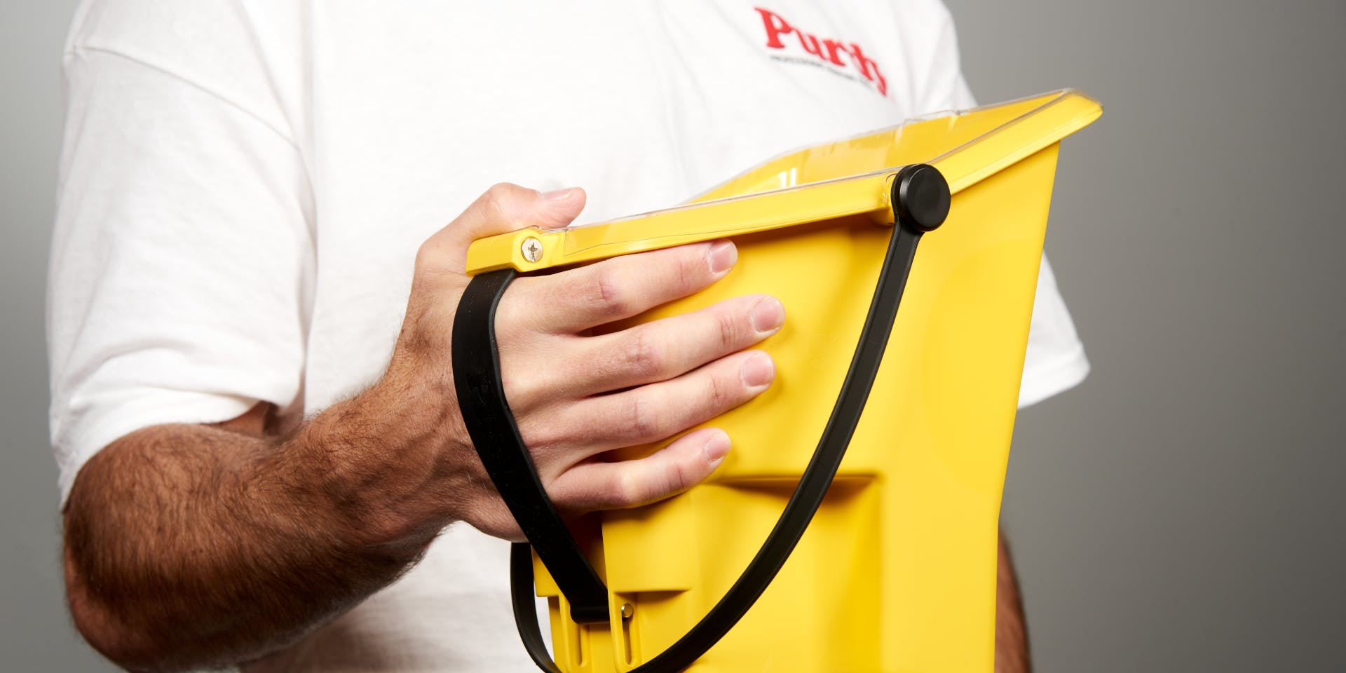 Man in Purdy shirt holding bucket