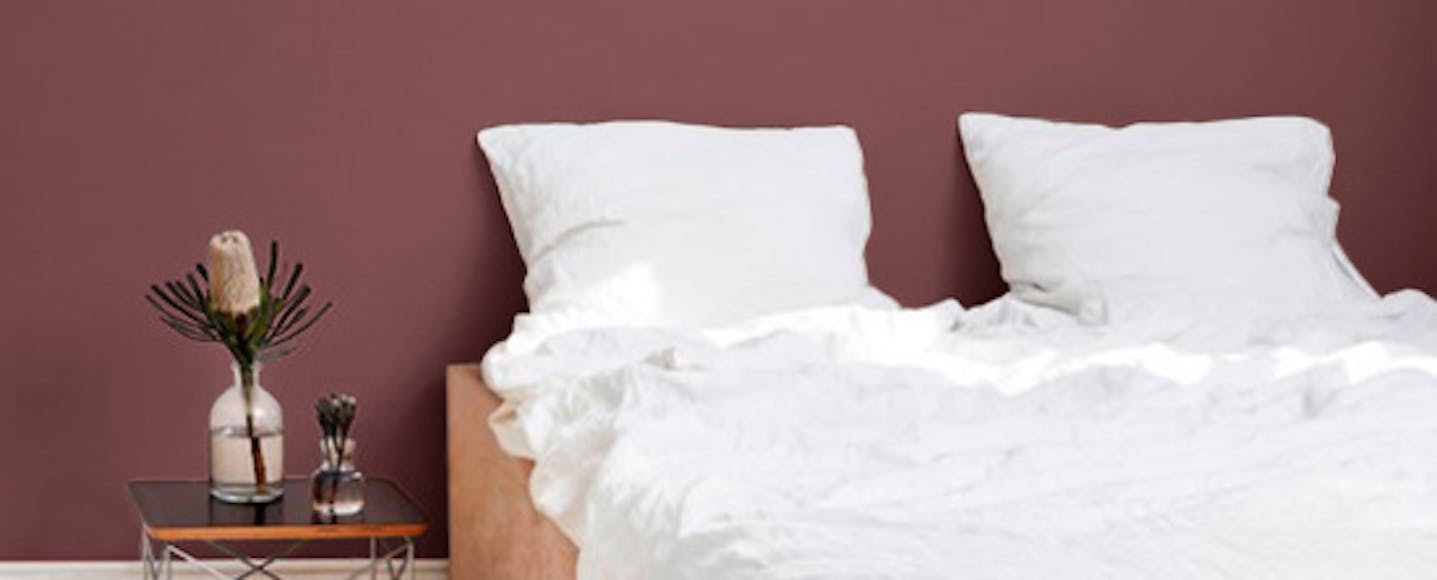 bedroom painted in a maroon paint colour