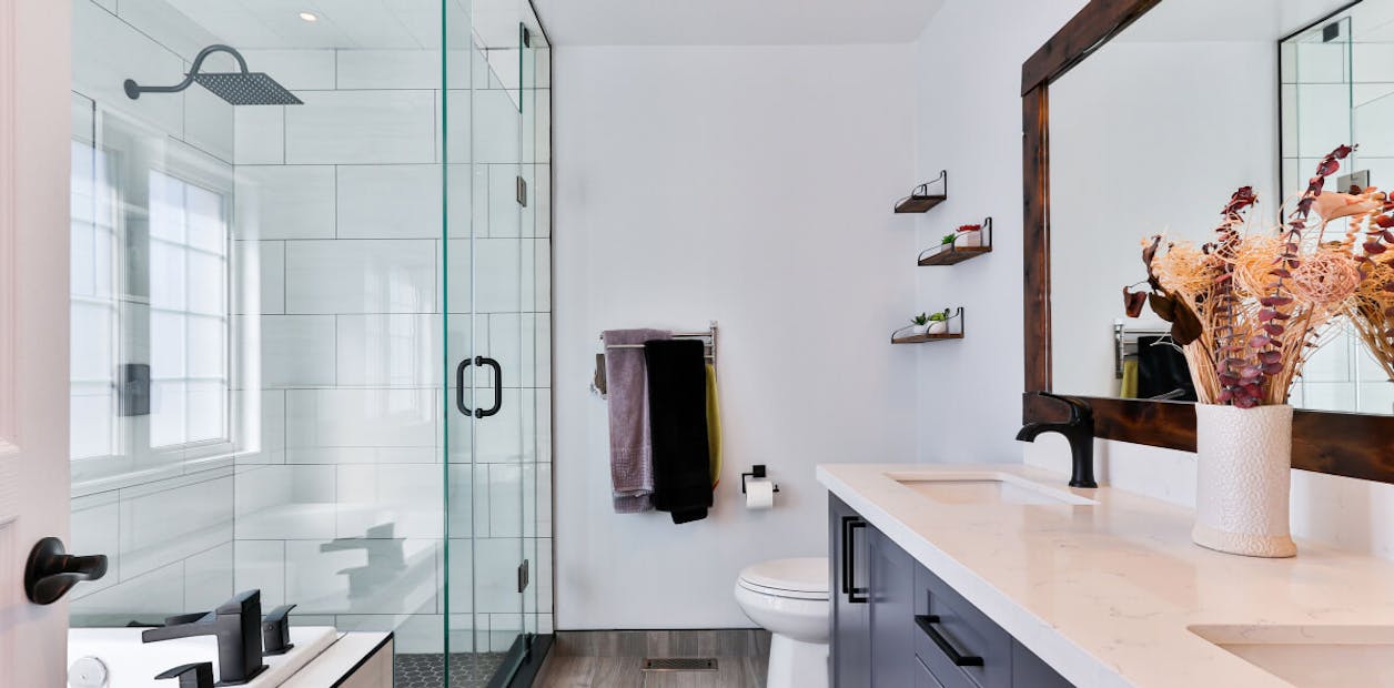 contemporary bathroom with a white wall and dark blue vanity unit