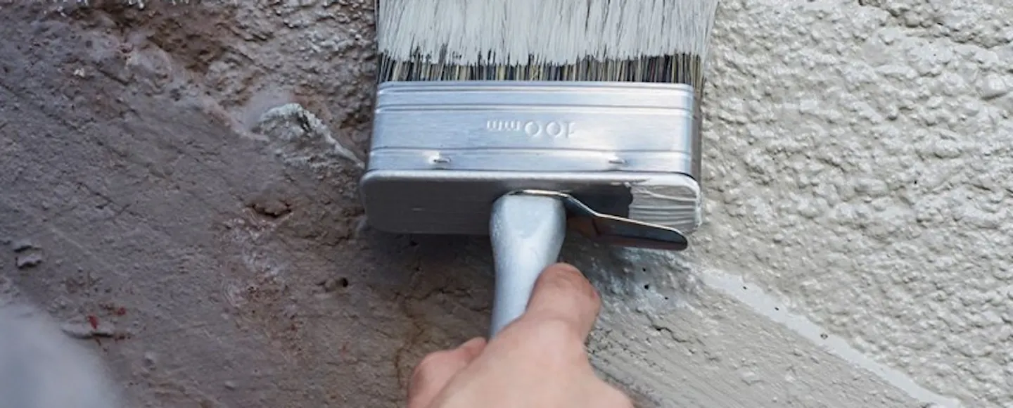 Exterior foundation being painted