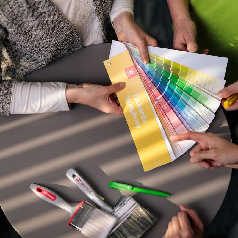 Person Choosing Colours From Fan Deck