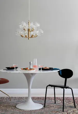 Dining table with grey wall and white trim behind