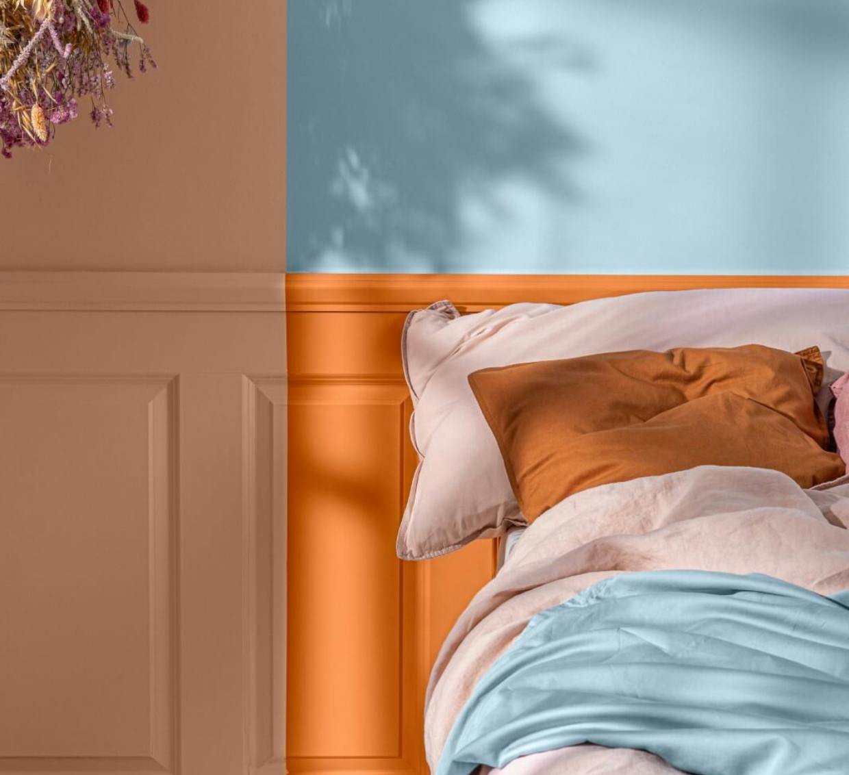 Bedroom painted in vibrant blue, orange and peach