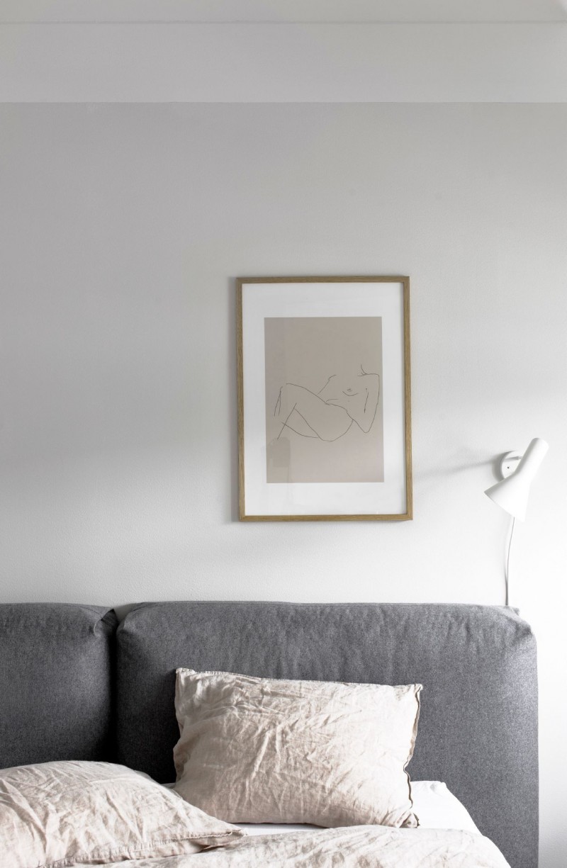 White Bedroom with Grey Bed and Hanging Pink Picture