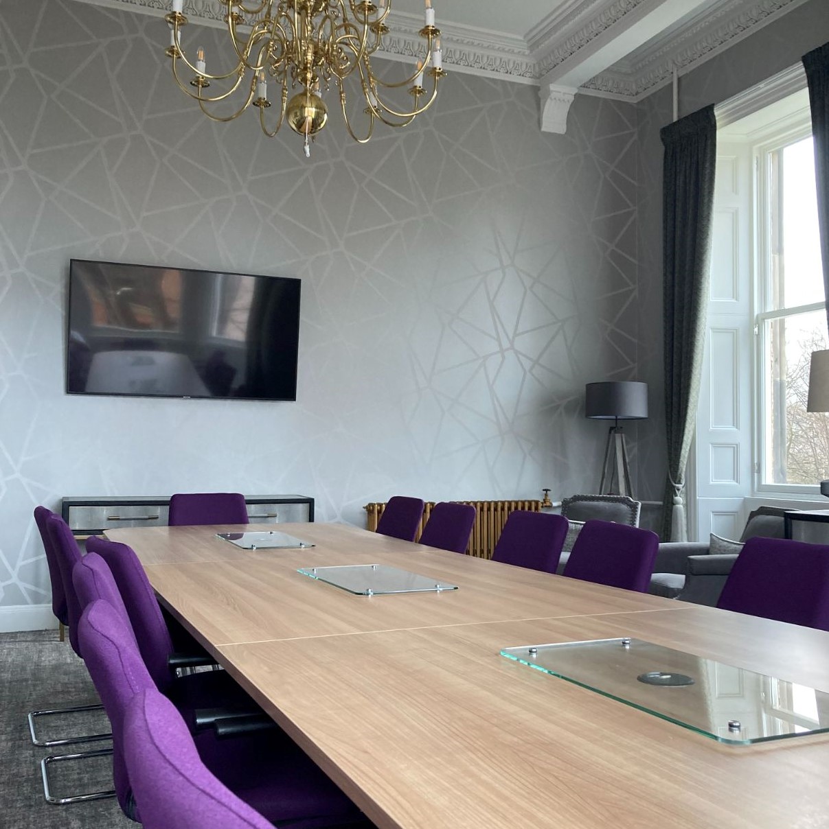 grey room with wooden table in the centre