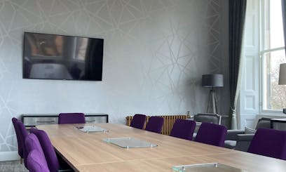 grey room with wooden table in the centre