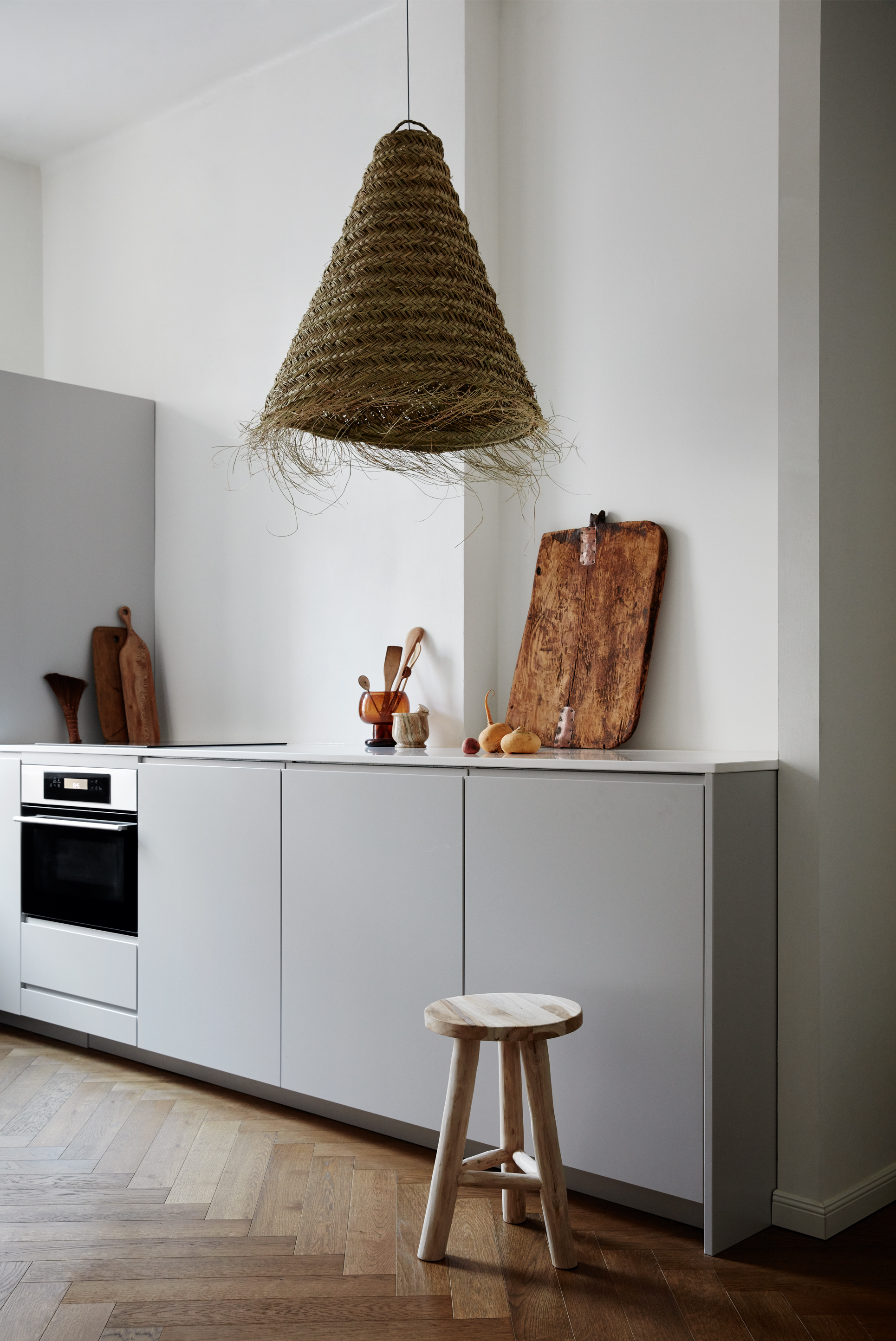 Kitchen with a white wall and grey cabinets