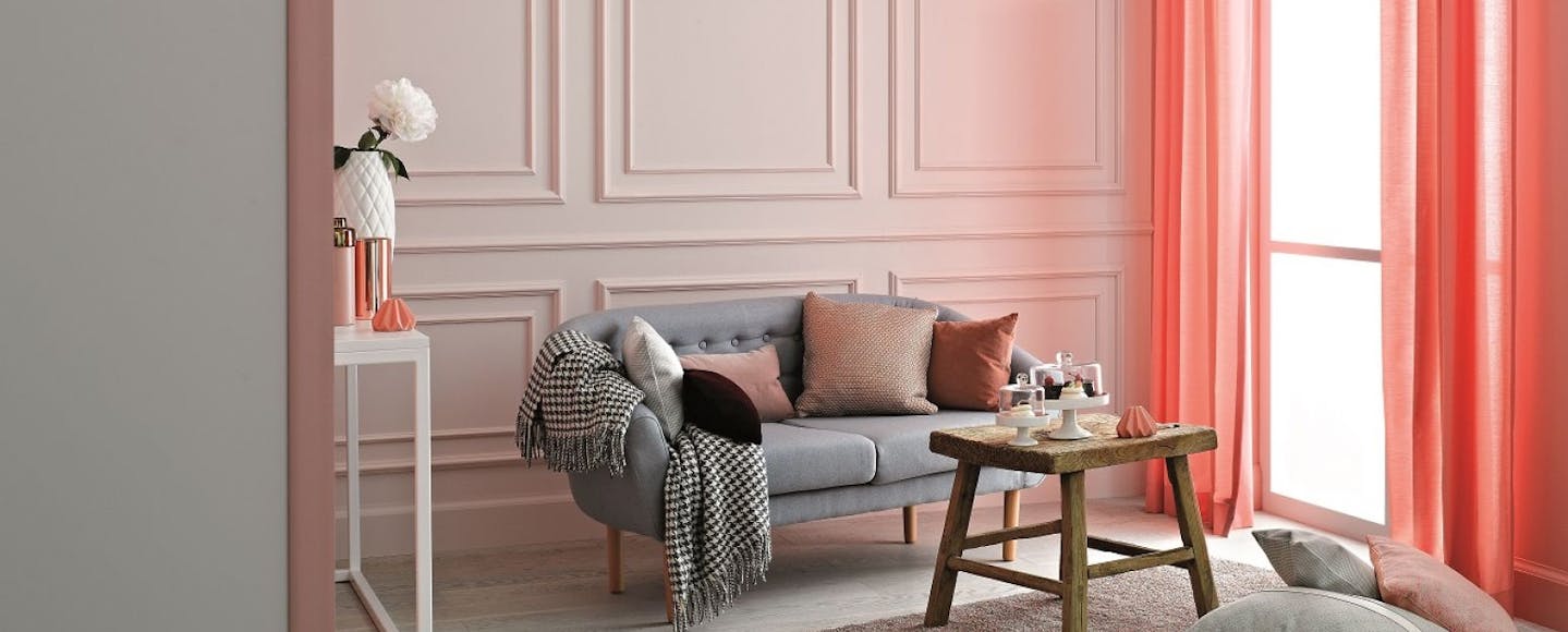 living room with pink panelled wall