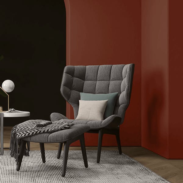 grey chair against burnt red wall