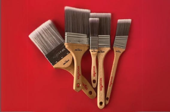 collection of 5 wooster paintbrushes against a red background