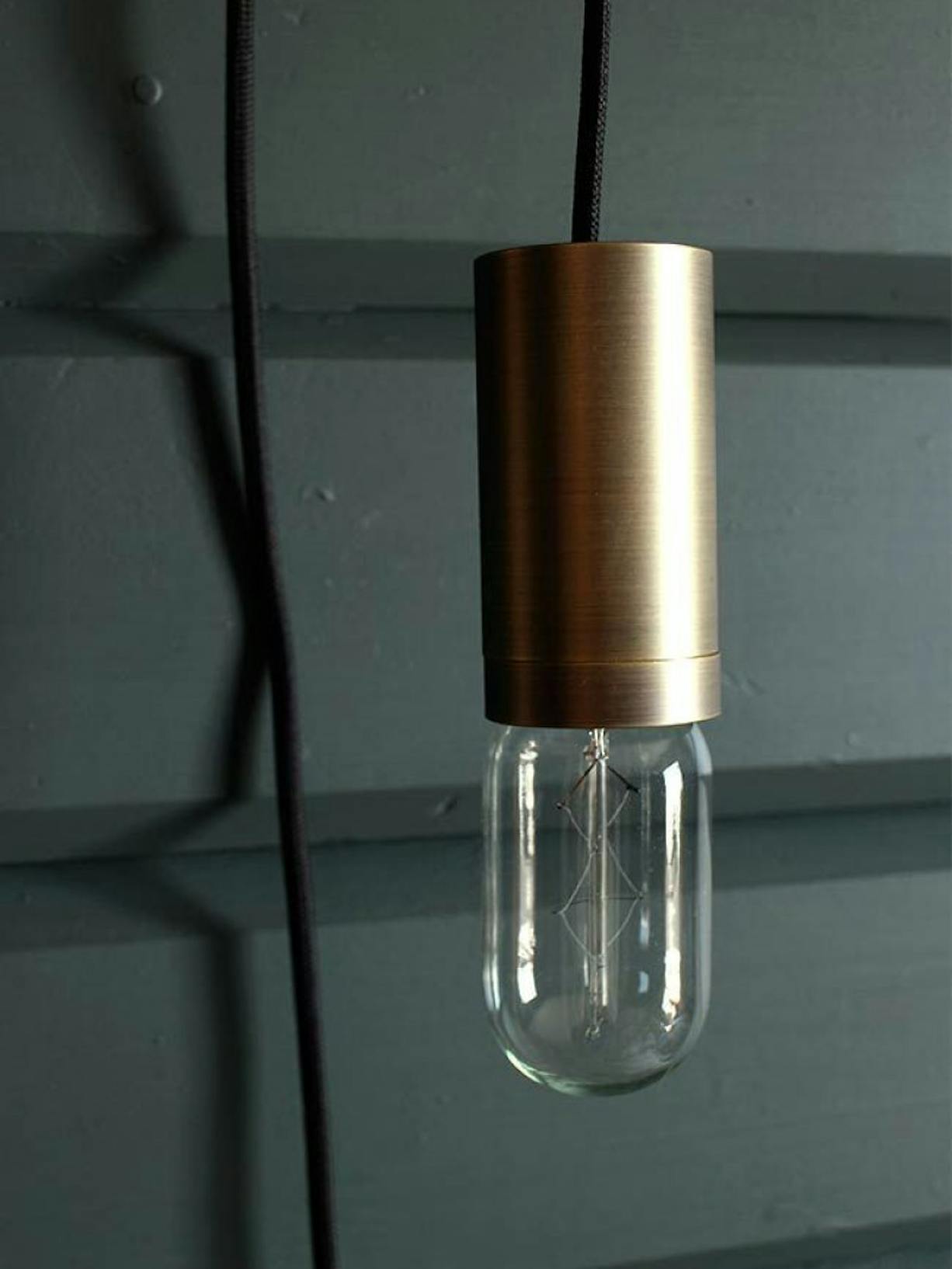 Close-up of Lamp Against Dark Green Wooden Wall